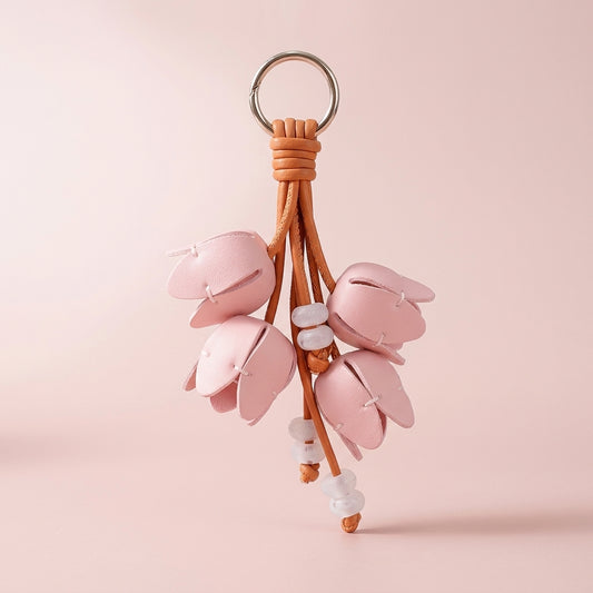 Pink faux leather tulip bag charm on a soft pink background